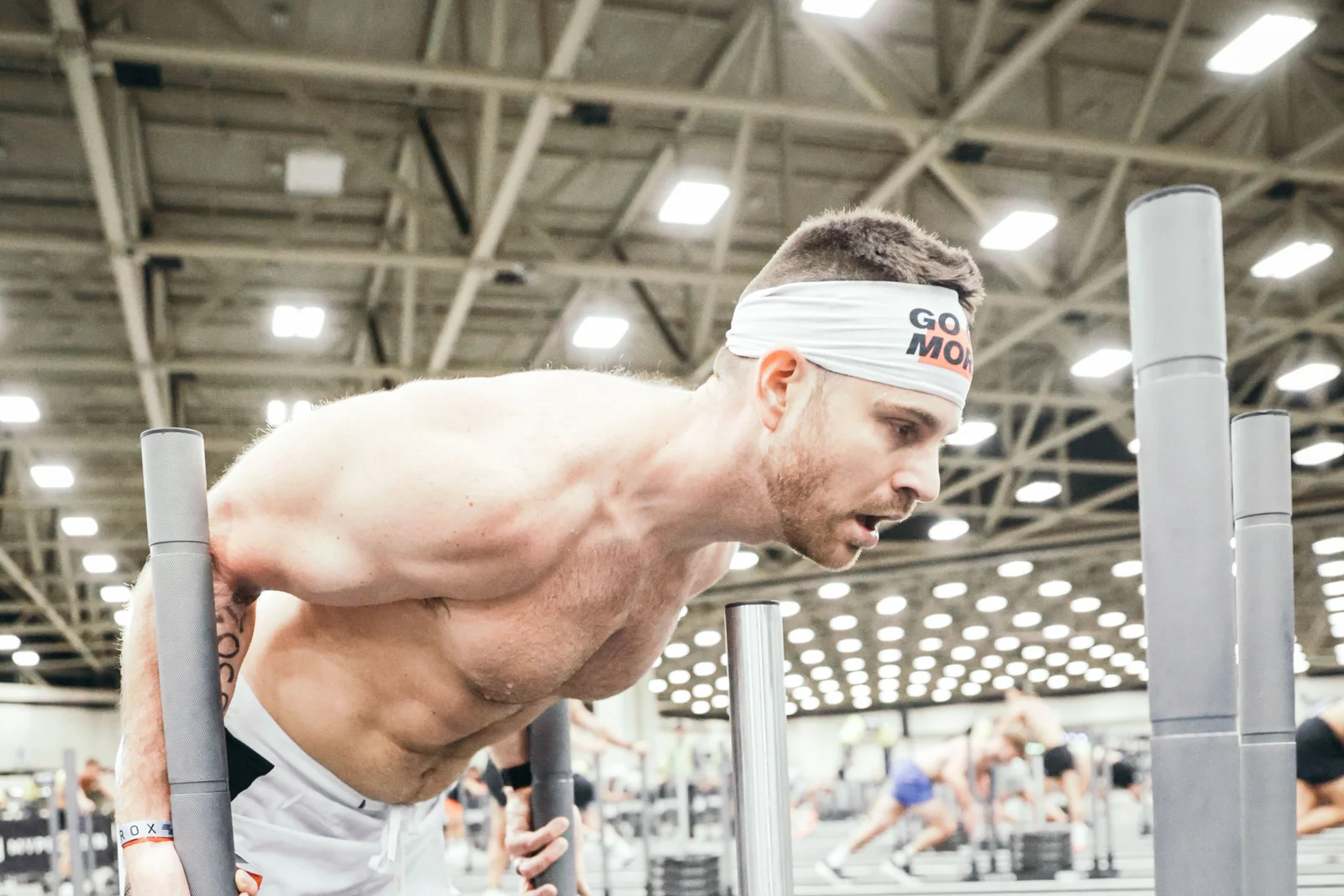 Storm Wilson pushing a weighted sled at a race event