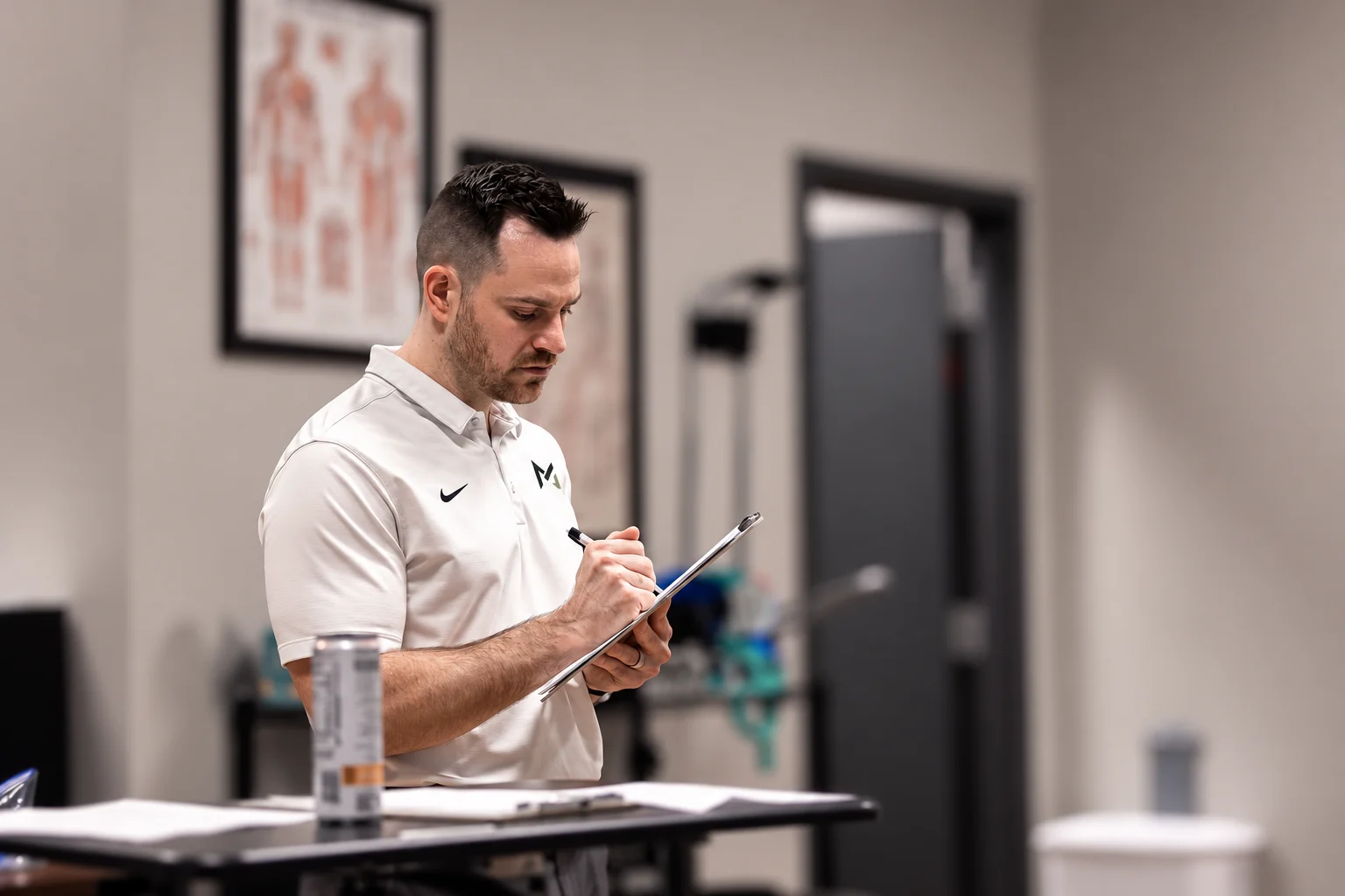 Storm Wilson taking notes on a clipboard in the MOTiV treatment space in Chattanooga