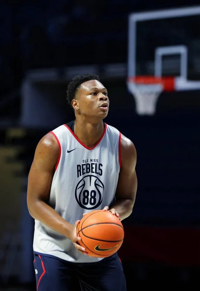 Christian Brown in an Ole Miss Rebels practice jersey holding a basketball